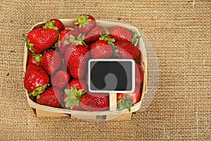 Strawberry in basket with price sign on canvas