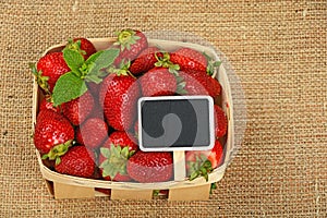 Strawberry in basket with price sign on canvas