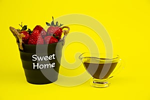 Strawberry berries and chocolate on a yellow background