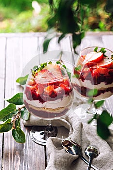 Strawberry berry cheesecake dessert in a cup, outdoors, close up, two desserts, summer