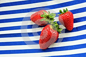 Strawberry on blue-white stripes background