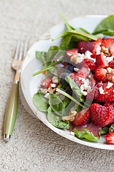 Strawberry blueberry walnut spinach salad side view