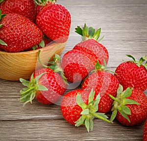 Strawberry in bowl on wooden