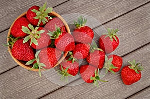 Strawberry in bowl on wooden