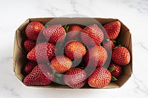 Strawberry box isolated on white marble background