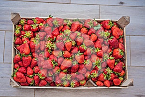 Strawberry box placed on a wooden table, healthy living concept