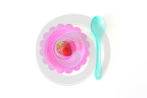 Strawberry on a bright saucer isolated white