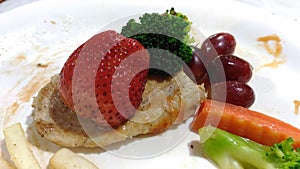 Strawberry broccoli grape on chicken steak