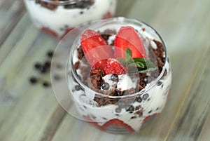 Strawberry Cake in Glass with White Crea mans Strawberry. Homemade summer dessert on white rustic table.