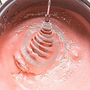 Strawberry cake,Mixing egg, flour and sugar cream in bowl with motor mixer. then baking a cake