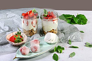 Strawberry cheesecake in glasses with fresh strawberries and cream cheese on gray background. Healthy homemade dessert., copy spac