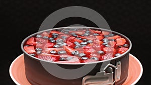 Strawberry cheesecake swirl in plate on black background