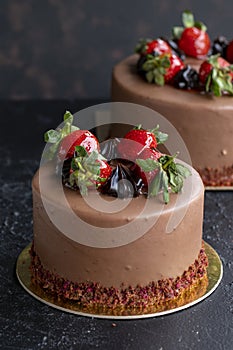 Strawberry and chocolate cake on a dark background. Close up brithday cake