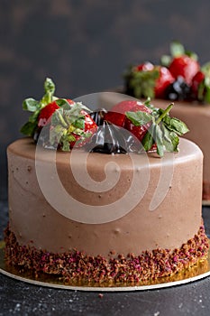 Strawberry and chocolate cake on a dark background. Close up brithday cake