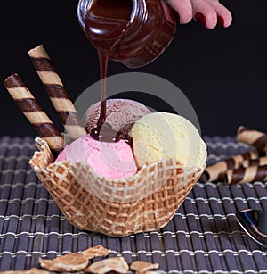 Strawberry chocolate ice cream and shortbread with falling chocolate syrup photo