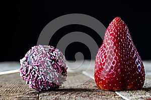 strawberry and chocolate on an old wooden table in an