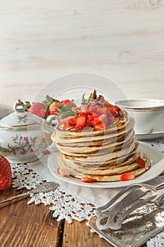 Strawberry chocolate pancakes on a vintage table