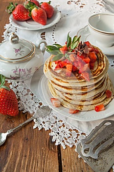 Strawberry chocolate pancakes on a vintage table