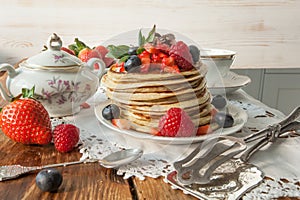 Strawberry chocolate pancakes on a vintage table