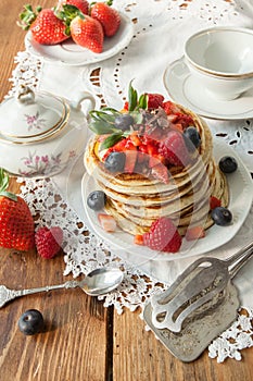 Strawberry chocolate pancakes on a vintage table