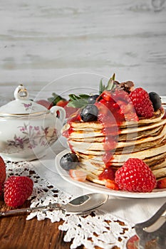 Strawberry chocolate pancakes on a vintage table