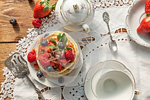 Strawberry chocolate pancakes on a vintage table