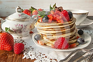 Strawberry chocolate pancakes on a vintage table