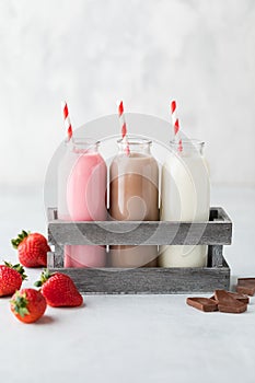 Strawberry, chocolate and vanilla milk.