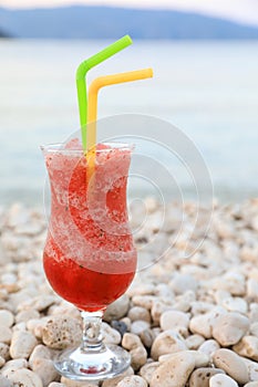 Strawberry cocktail. Evening relaxation with a glass of strawberry cocktail during the summer holidays on the Antisamos beach,