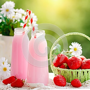 Strawberry cocktail or milkshake in a jar, basket with strawberries on a picnic, healthy food for Breakfast and snacks