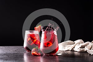 Strawberry cocktail splashing in a glass