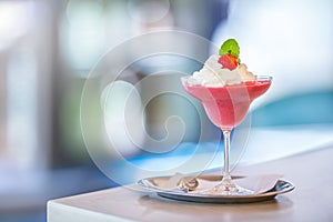 Strawberry cocktail with whipped cream and mint leaves on bar