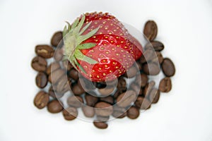 Strawberry and coffee beans. Strawberry on coffee.
