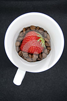 Strawberry and coffee beans. Strawberry on coffee.