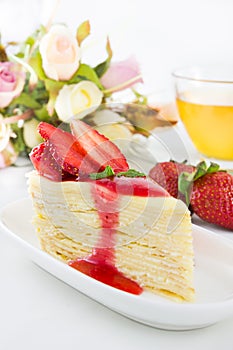 Strawberry crape cake with tea cup