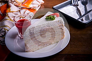 strawberry crape cake on wood table in coffee shop , dessert tasy cake