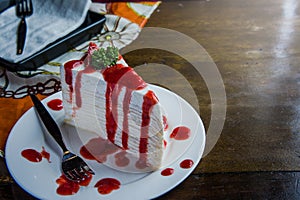 strawberry crape cake on wood table in coffee shop , dessert tasy cake