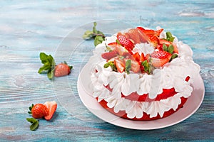 Strawberry and cream sponge cake. Homemade summer dessert on blue wooden table
