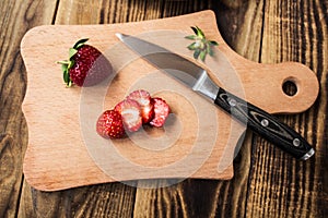 Strawberry on cutting board and knife