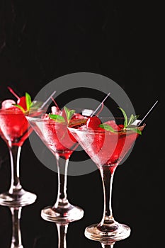 Strawberry daiquiri cocktail with lime, strawberry, cherry and m