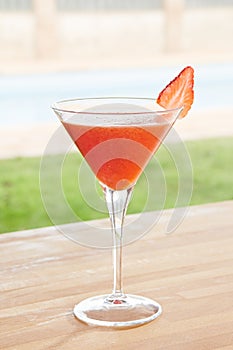 Strawberry daiquiri cocktail by a pool outdoors