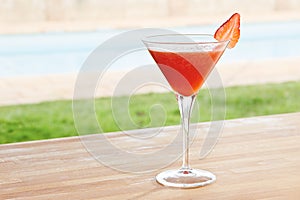 Strawberry daiquiri cocktail by a pool outdoors