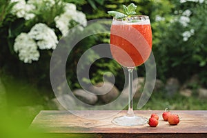 Strawberry daiquiri. Glass of summer strawberry cocktail outdoors.