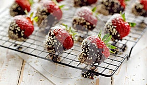Strawberry dessert, Dark chocolate covered strawberries, fresh strawberries dipped in melted dark chocolate sprinkled with sesame