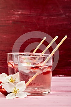 Strawberry detox water with jasmine flower. Summer iced drink