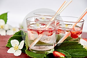 Strawberry detox water with jasmine flower. Summer iced drink