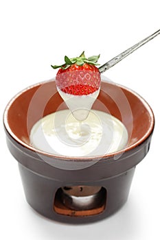 Strawberry dipped in white chocolate fondue