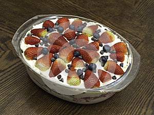 Strawberry dish with cream and blueberries