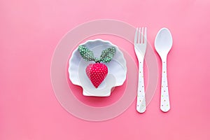 Strawberry on dish with pastel color background.