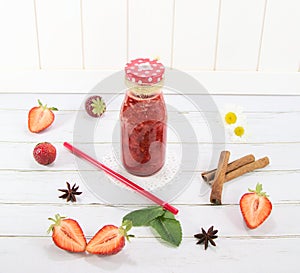 Strawberry drink in a glass jar, on a white background.